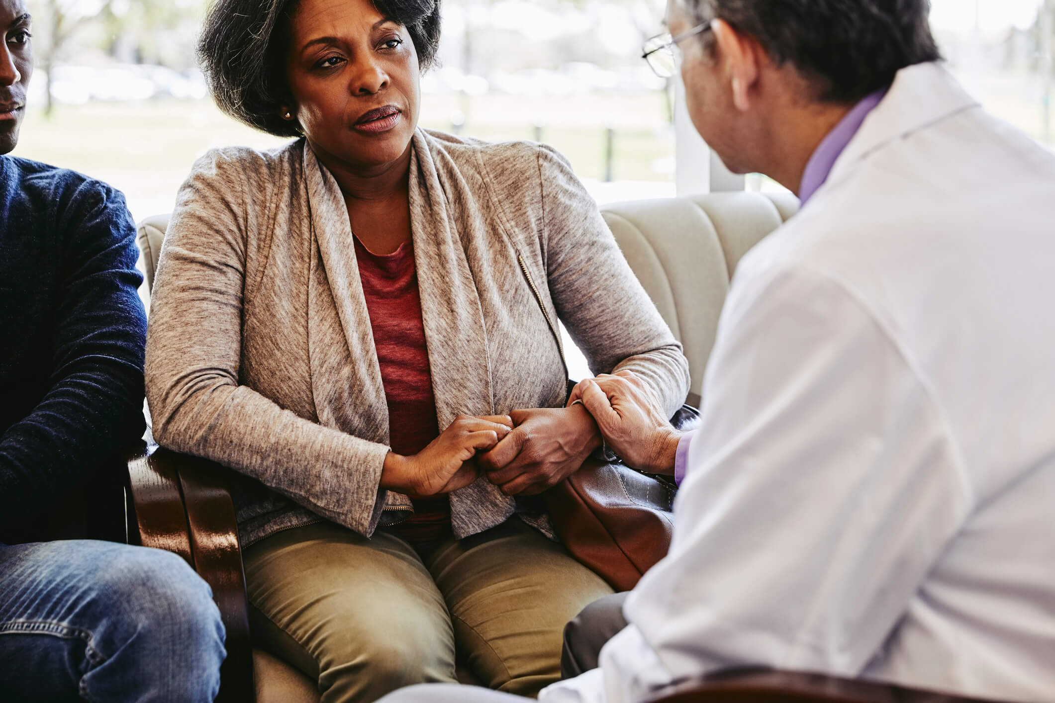 Doctor talking to older black female patient.