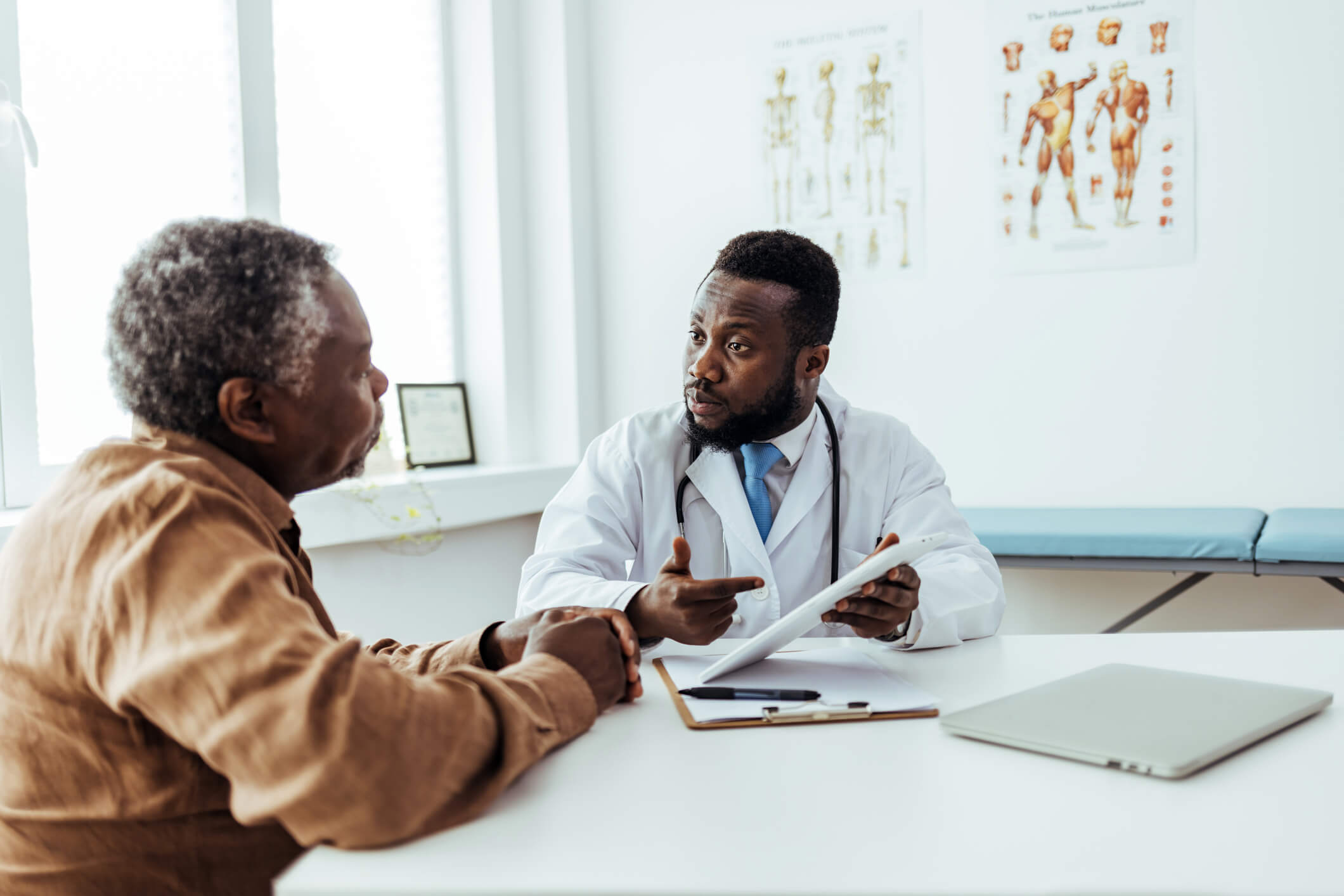 Black patient talking to doctor.