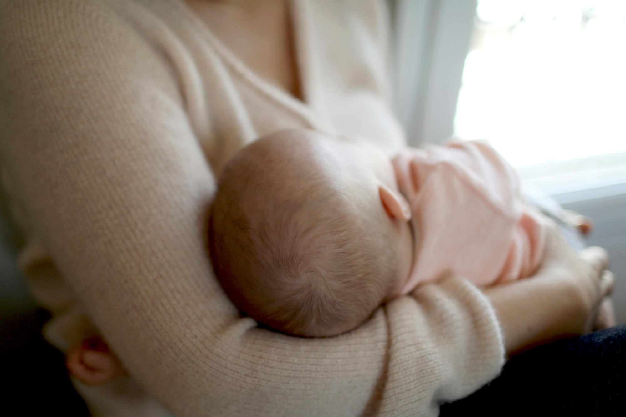 A cancer survivor breastfeeds her child.