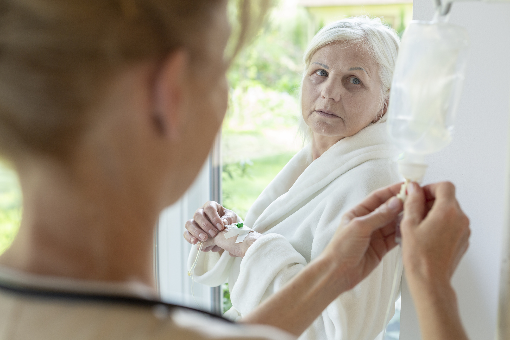 doctor with older woman patient receiving chemotherapy