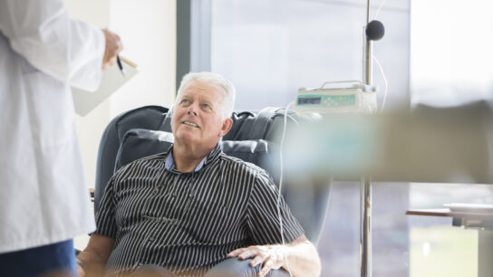 Doctor talking to patient receiving an infusion