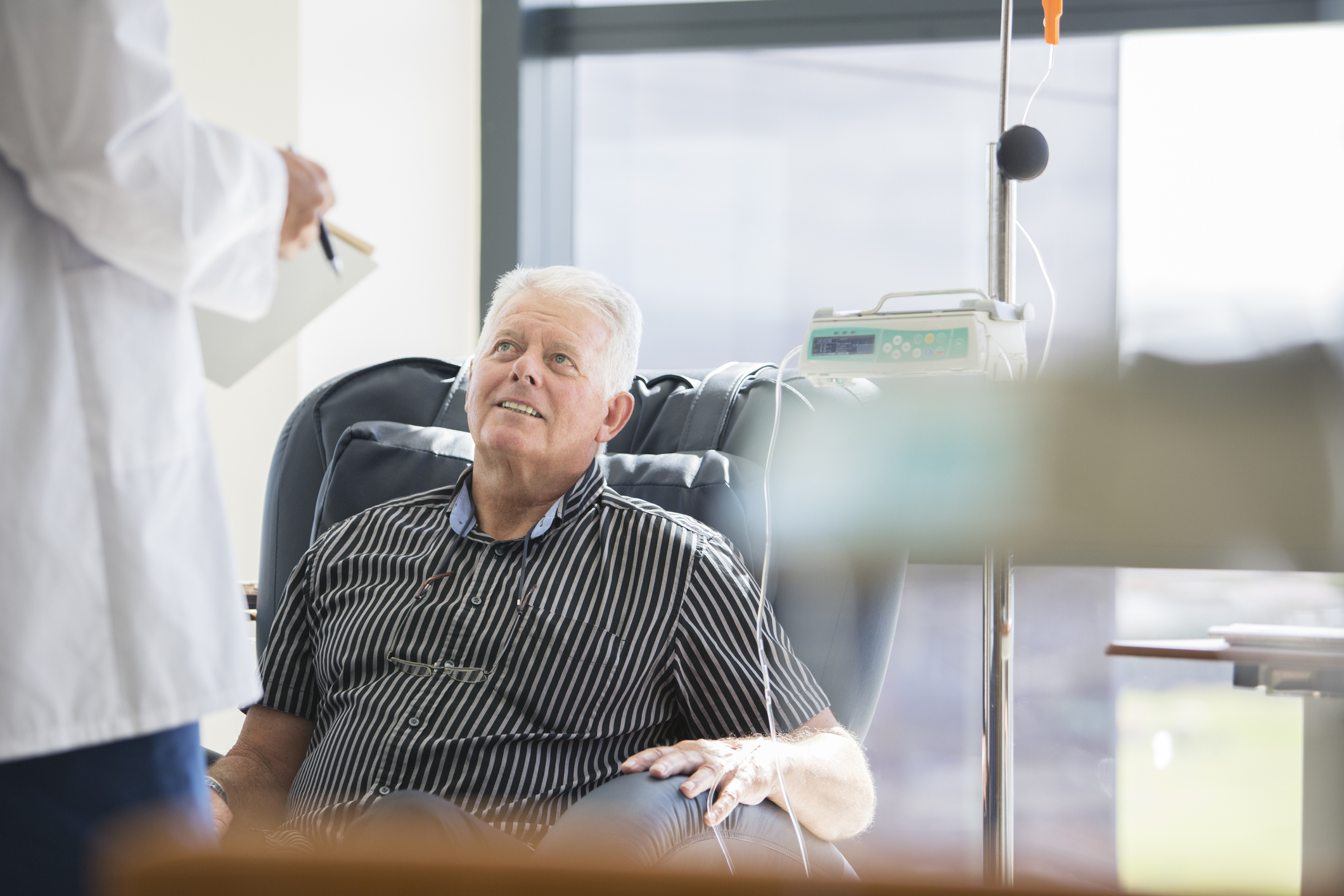 Doctor talking to patient receiving an infusion