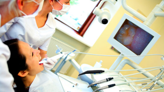 A patient with cancer undergoes preoperative oral care.