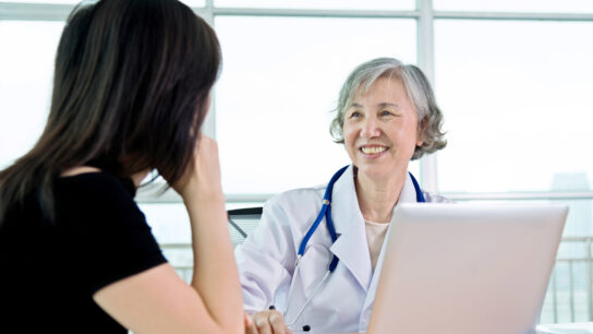 Senior female doctor talking to her patient.