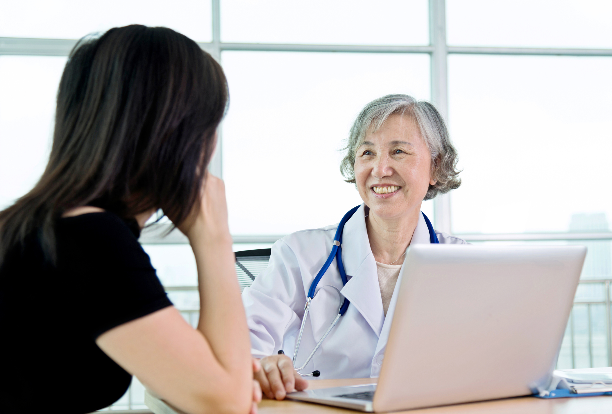 Senior female doctor talking to her patient.