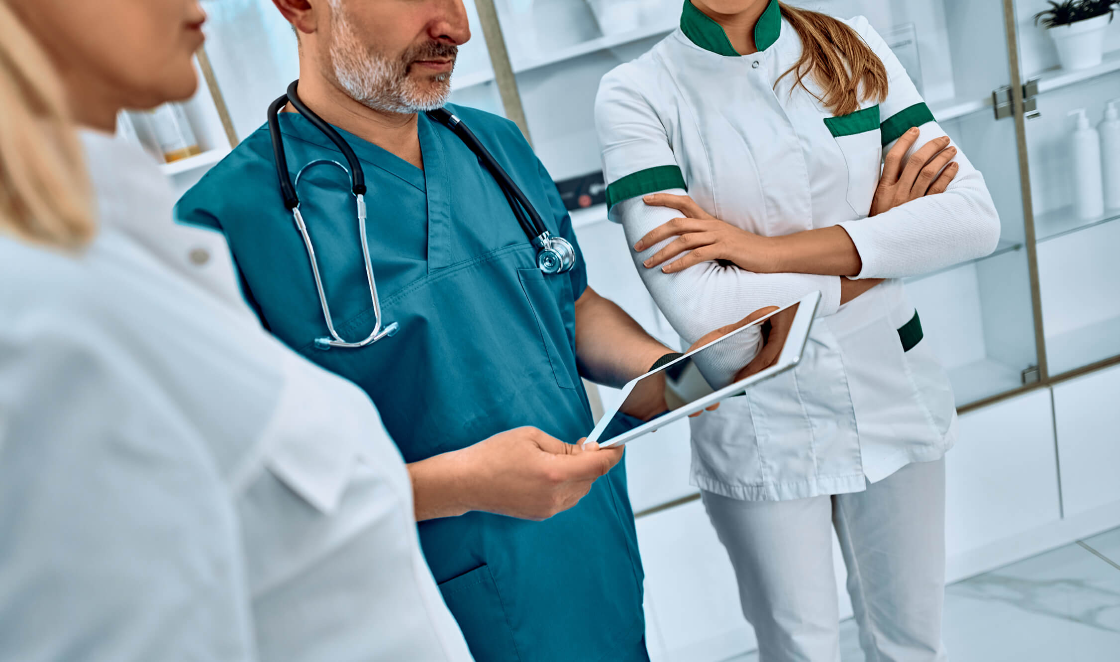 Doctors looking at tablet.