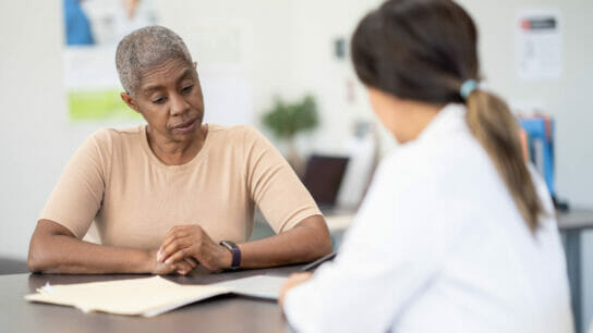 A doctor discusses test results and treatment plan with a patient.