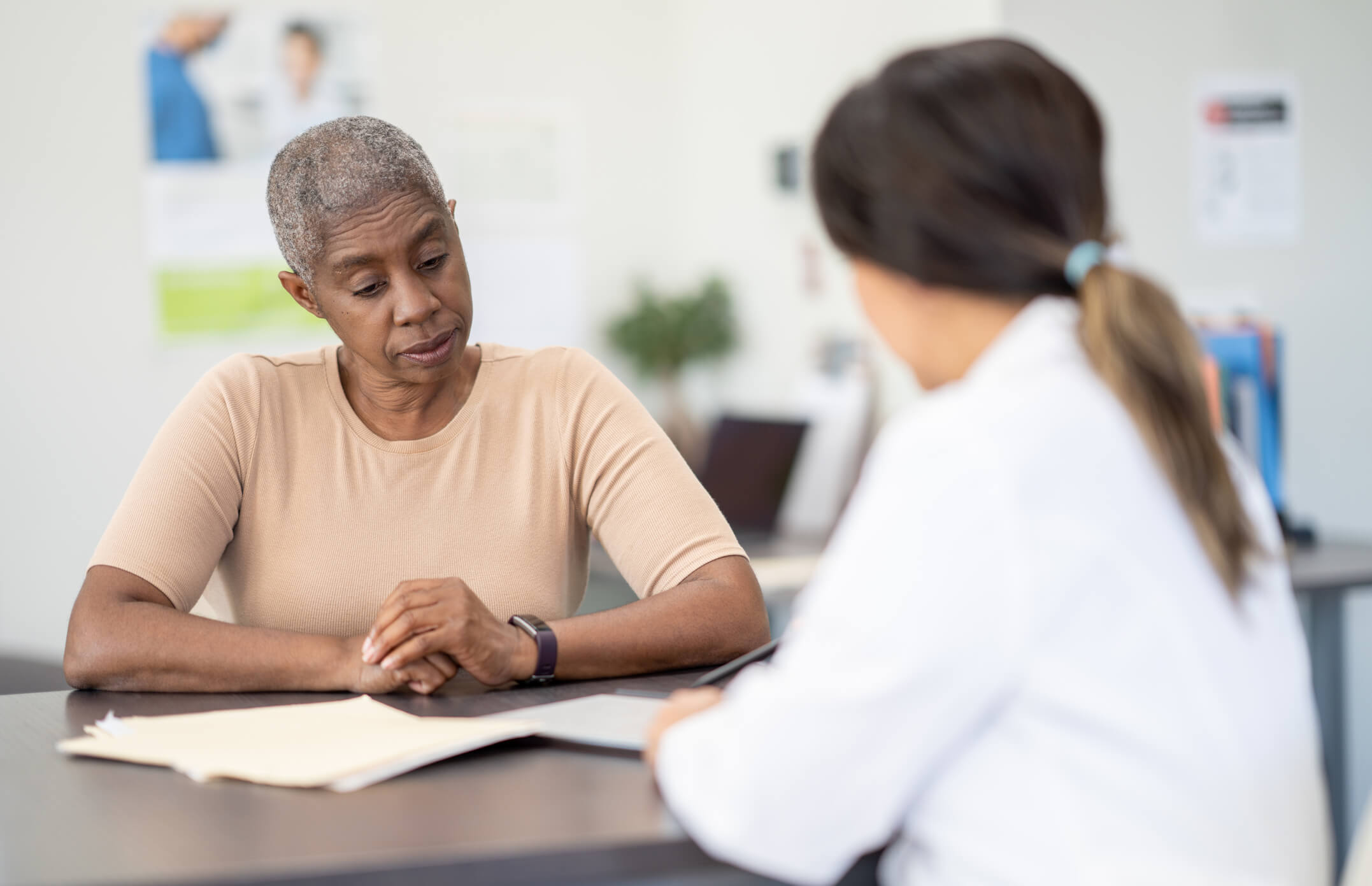 A doctor discusses test results and treatment plan with a patient.