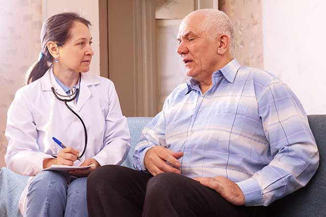 Conferring with an older patient with cancer.