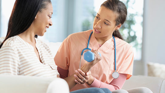 A nurse and patient discuss an exercise regimen.