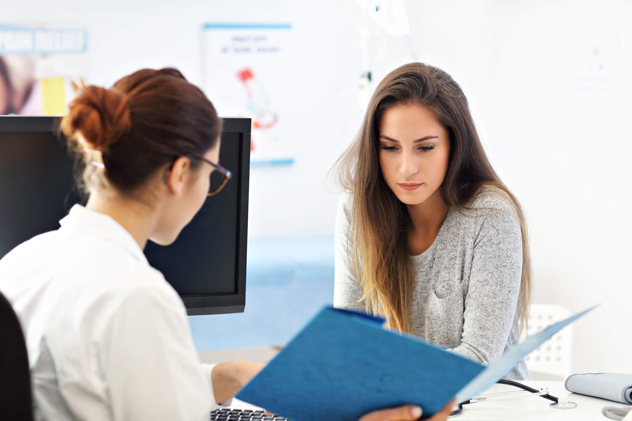 Female patient talking to doctor.