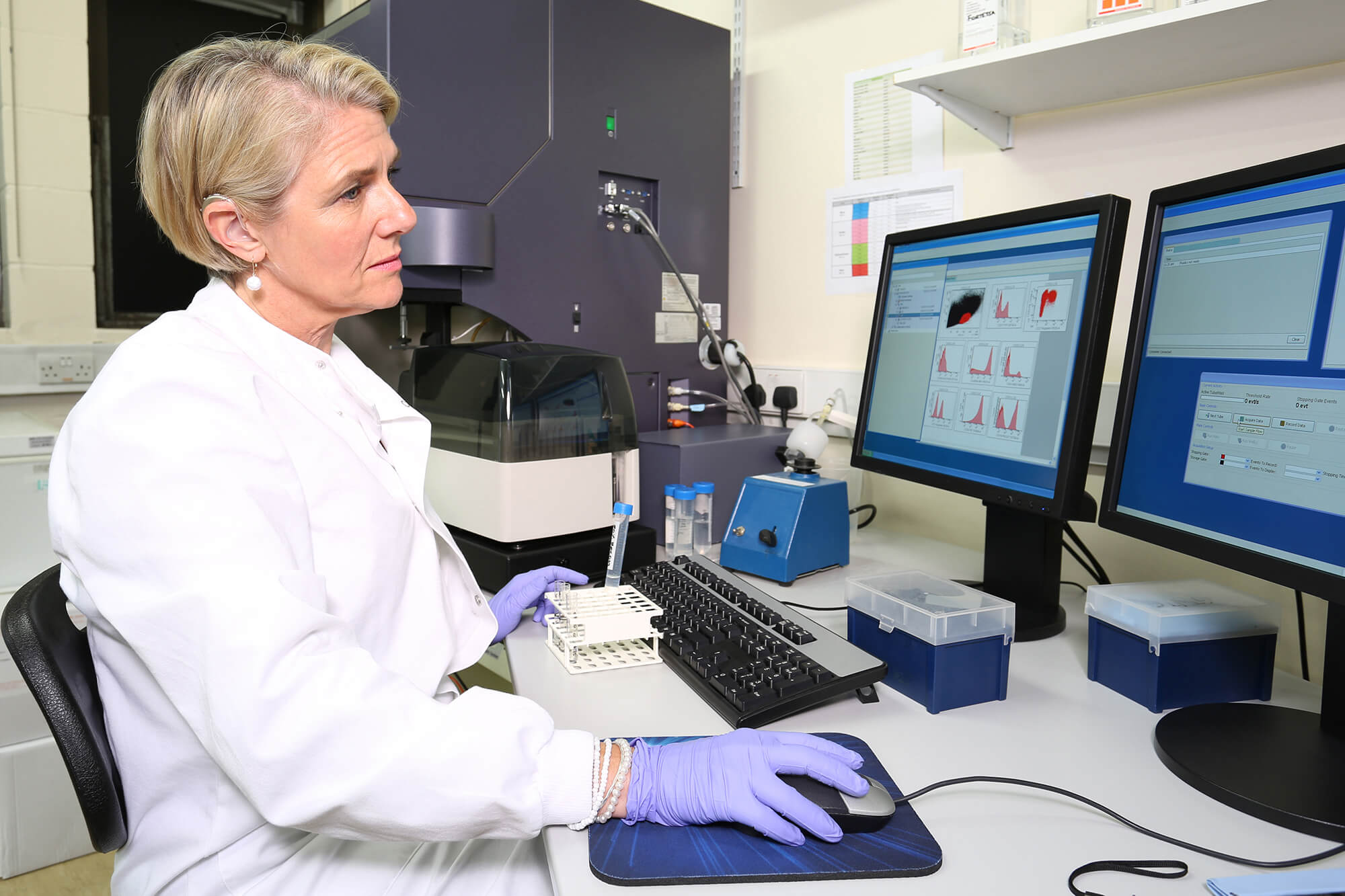 A clinician uses a flow cytometer