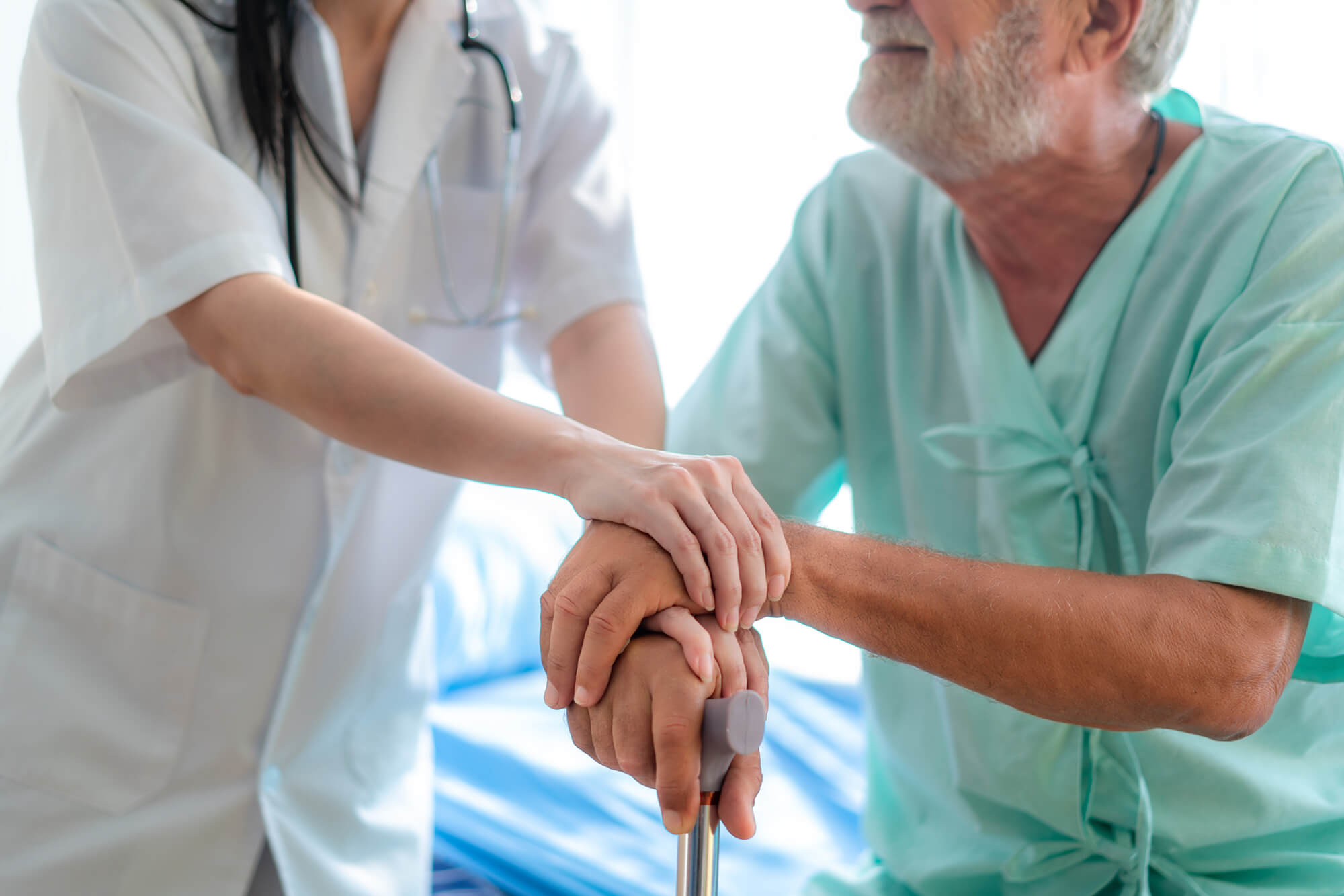 A nurse assists an older patient.