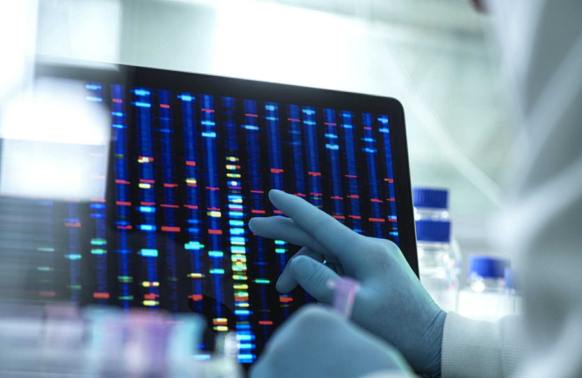 Scientist examining genetic testing results on a screen