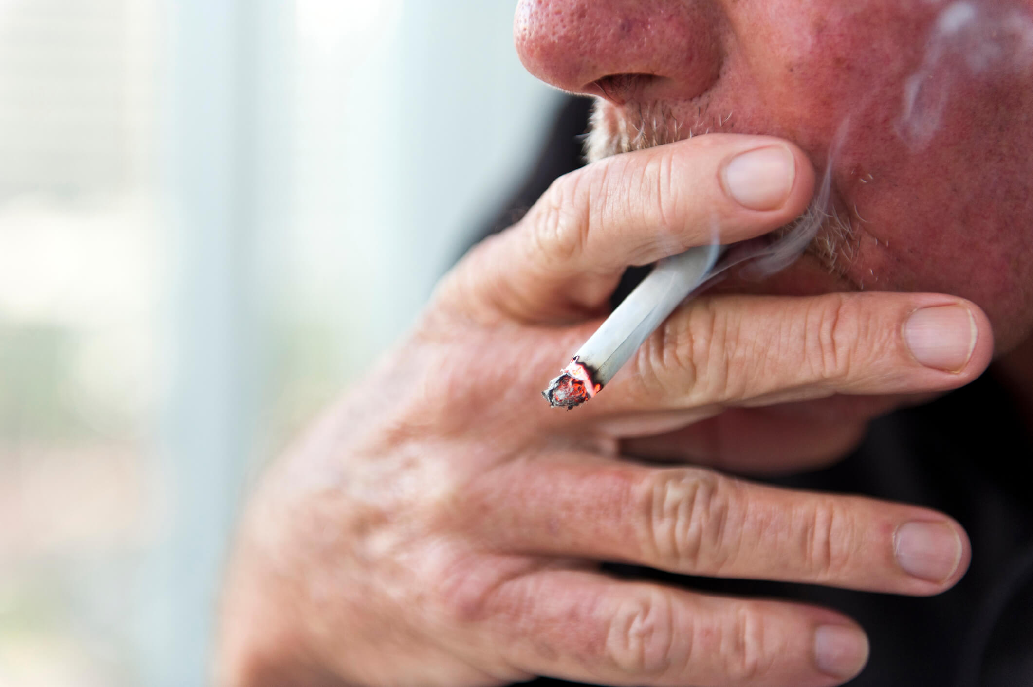 Older White man smoking a cigarette