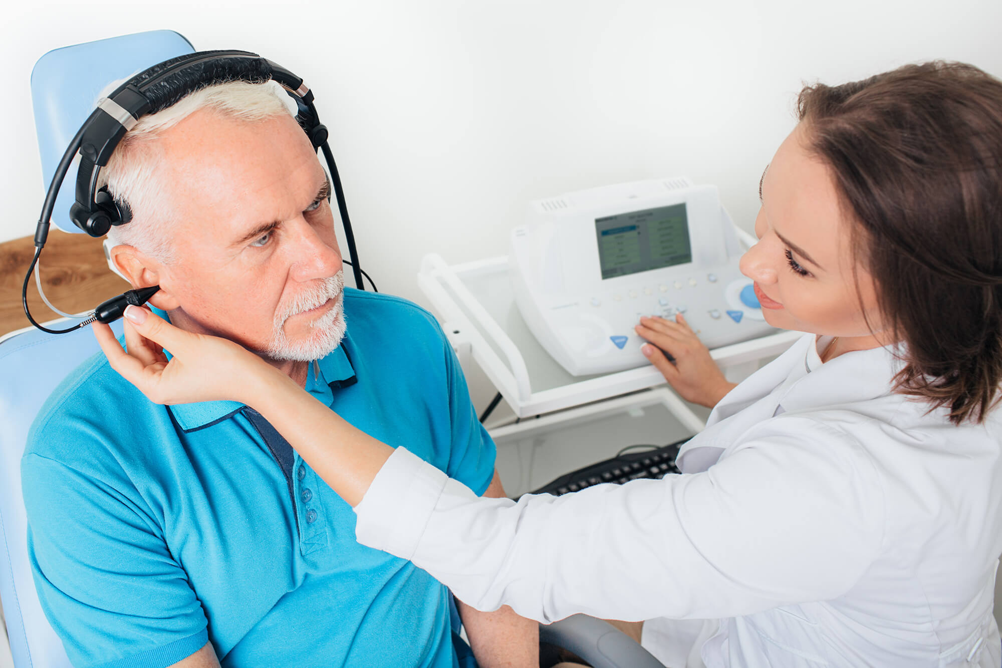 Senior man in hospital having a hearing test.