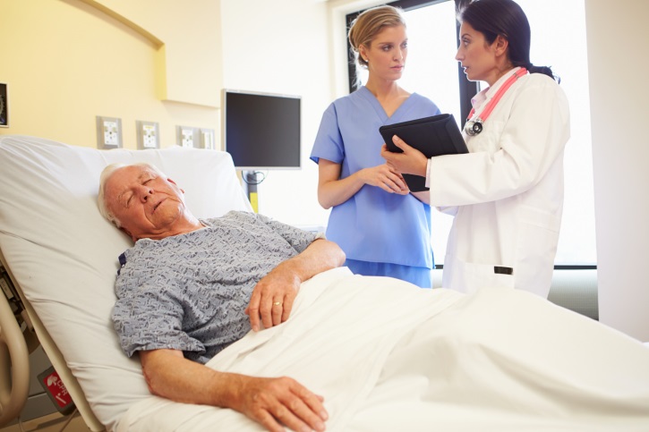 Senior man eyes closed in hospital bed