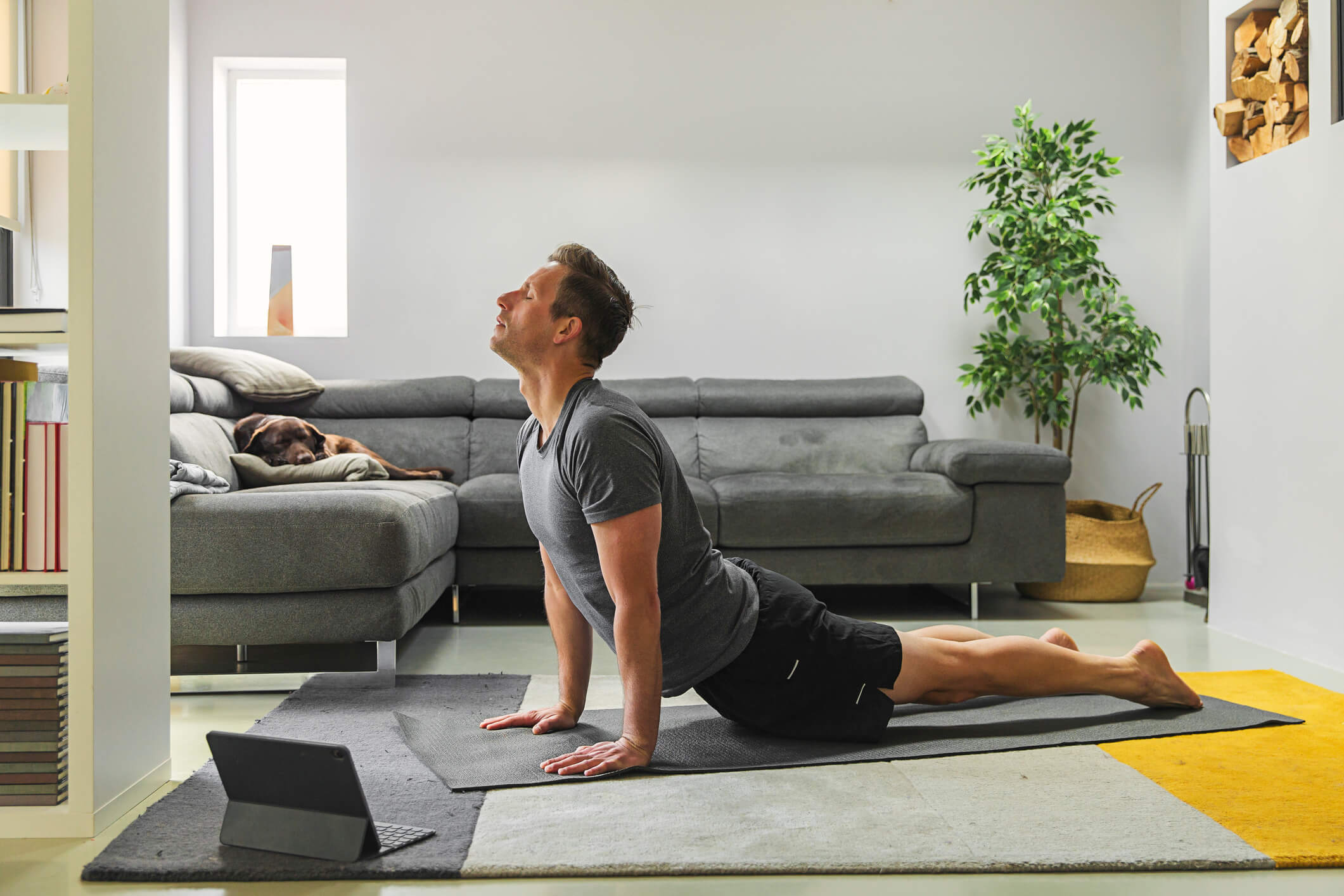 Man doing yoga at home.