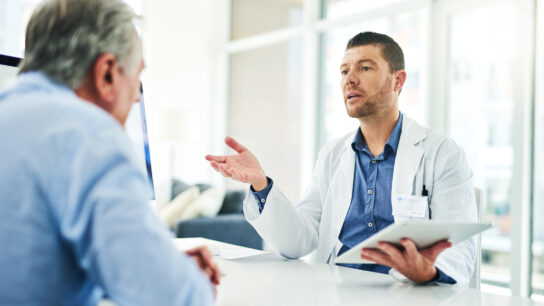 Cropped shot of a focused middle aged doctor consoling with a patient inside of his office during the day