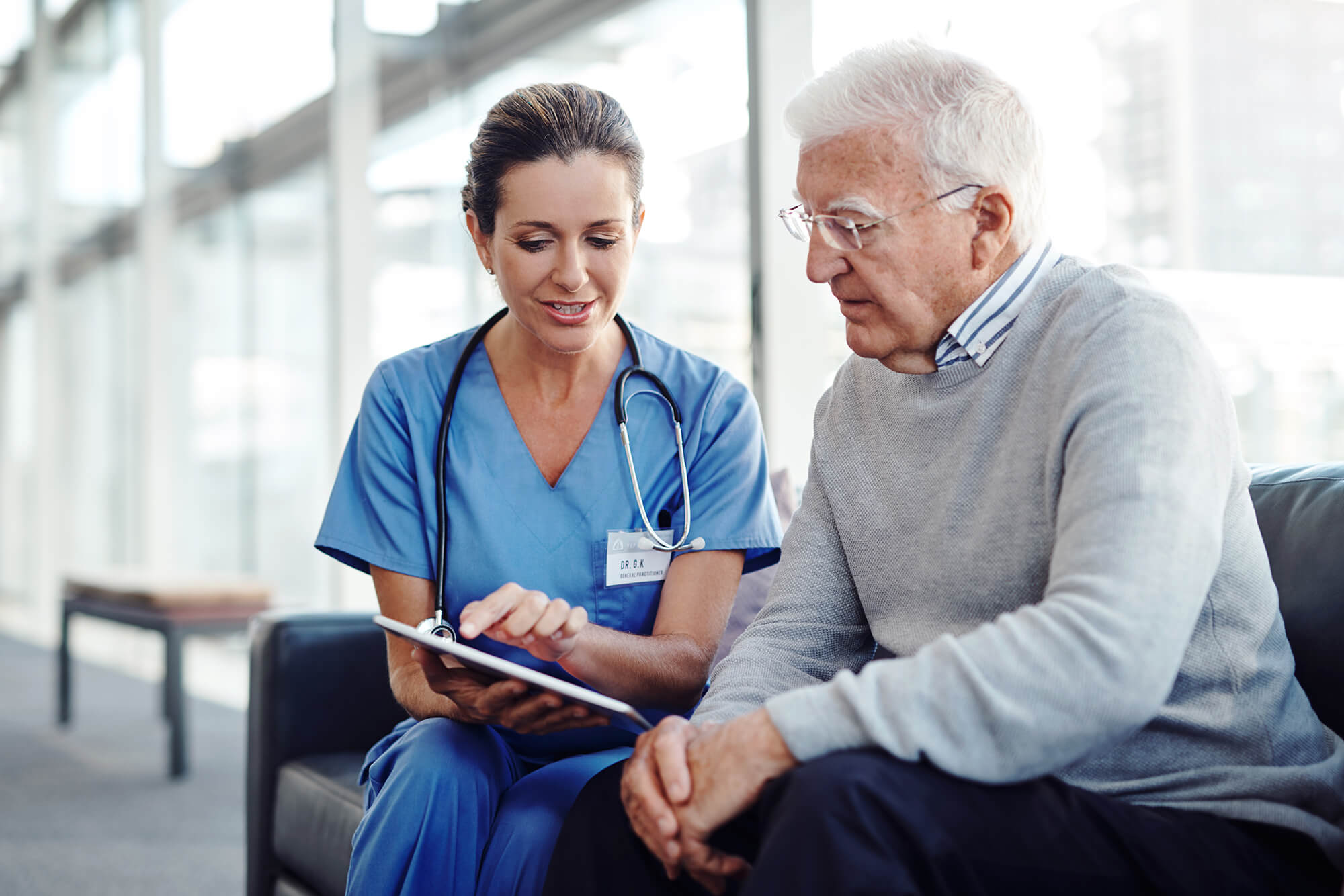 A nurse navigator discusses upcoming treatment plans with a patient.