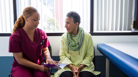 Nurse talking to female patient.