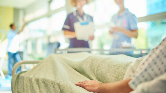 Patient in hospital bed.