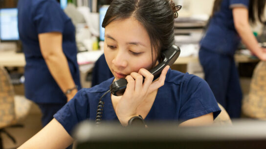 Nurse talking over the phone.