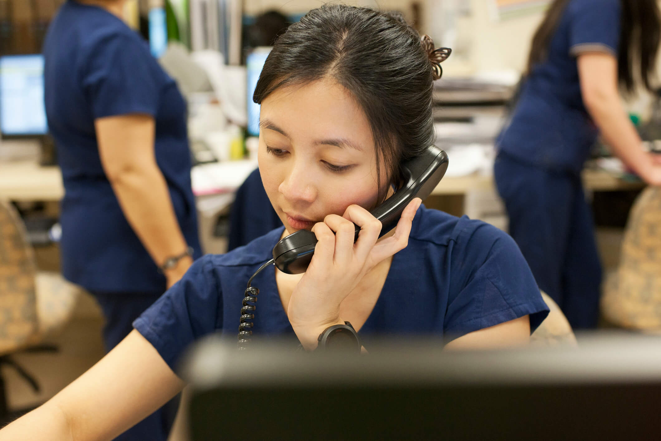 Nurse talking over the phone.