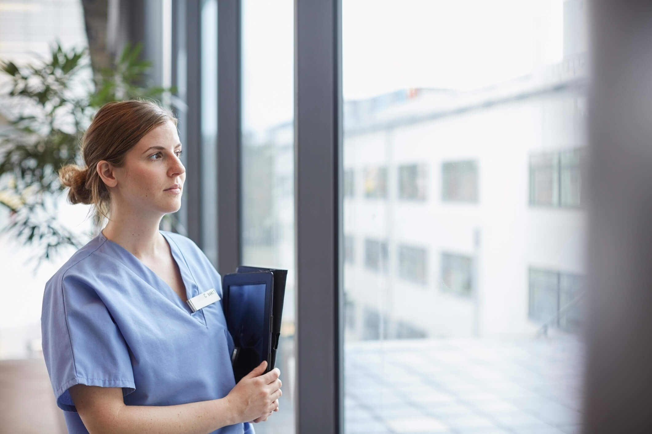 Nurse looking out a window.