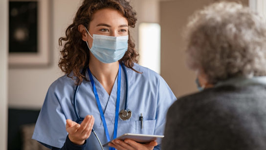 Nurse talking to patient.