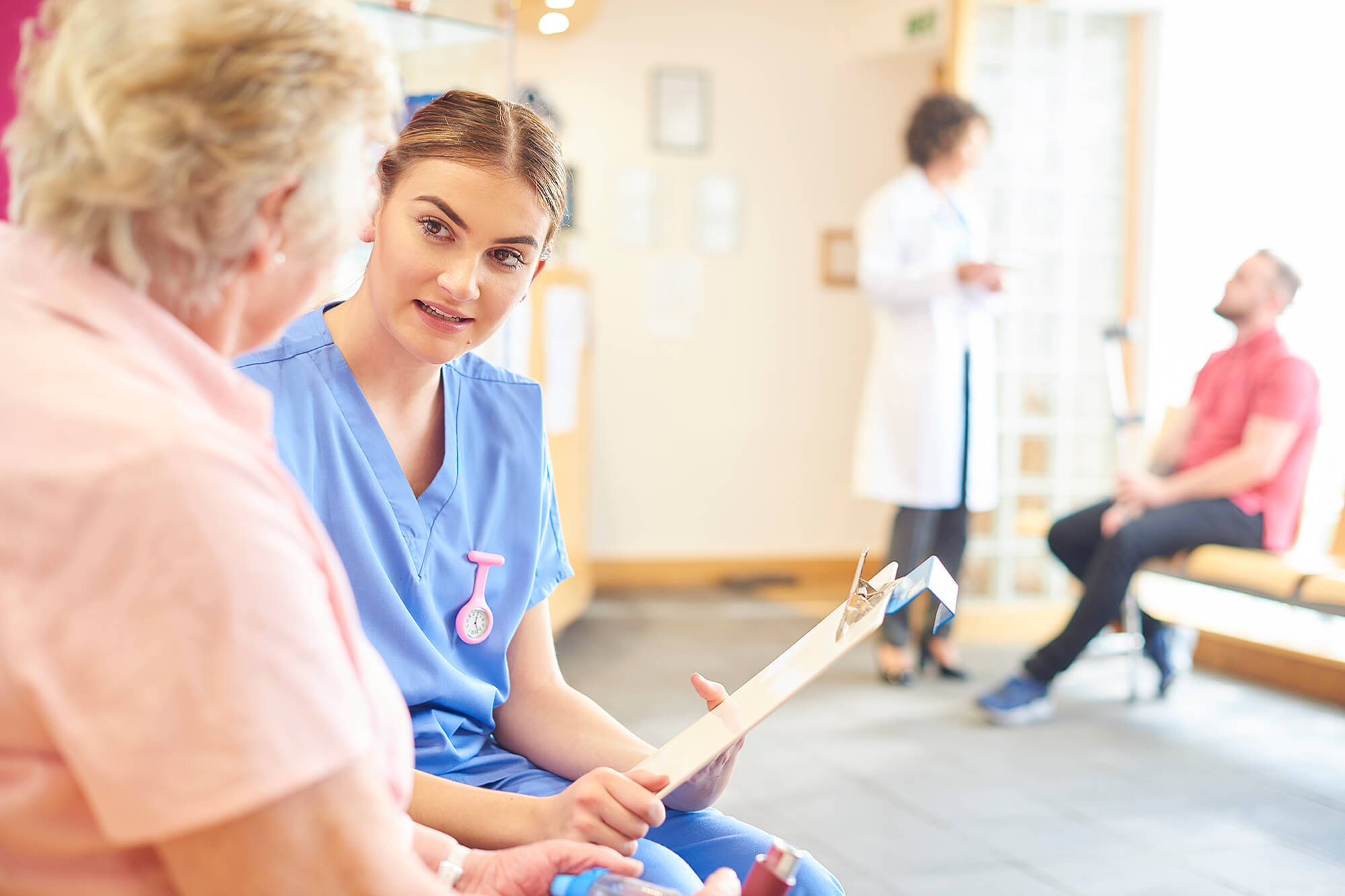 A nurse reviews a treatment plan with her patient.