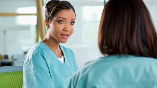 Nurses discussing cancer therapy.