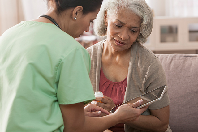 A nurse discusses medication dosage with a patient.