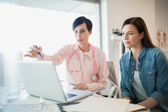 A caregiver receives training from an oncology professional.