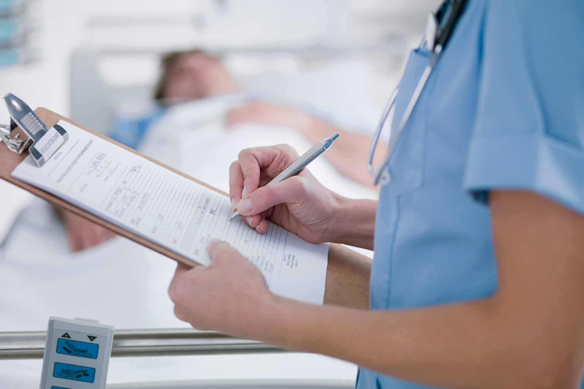 Nurse tending patient in intensive care.