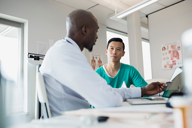 A clinician discusses test results with a patient.