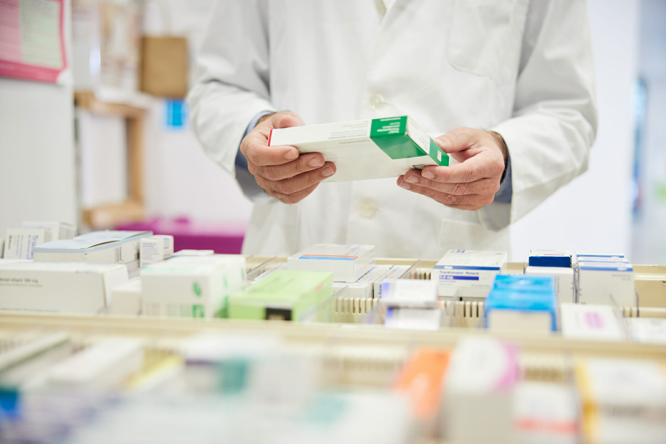 Pharmacist holding a box of medicine