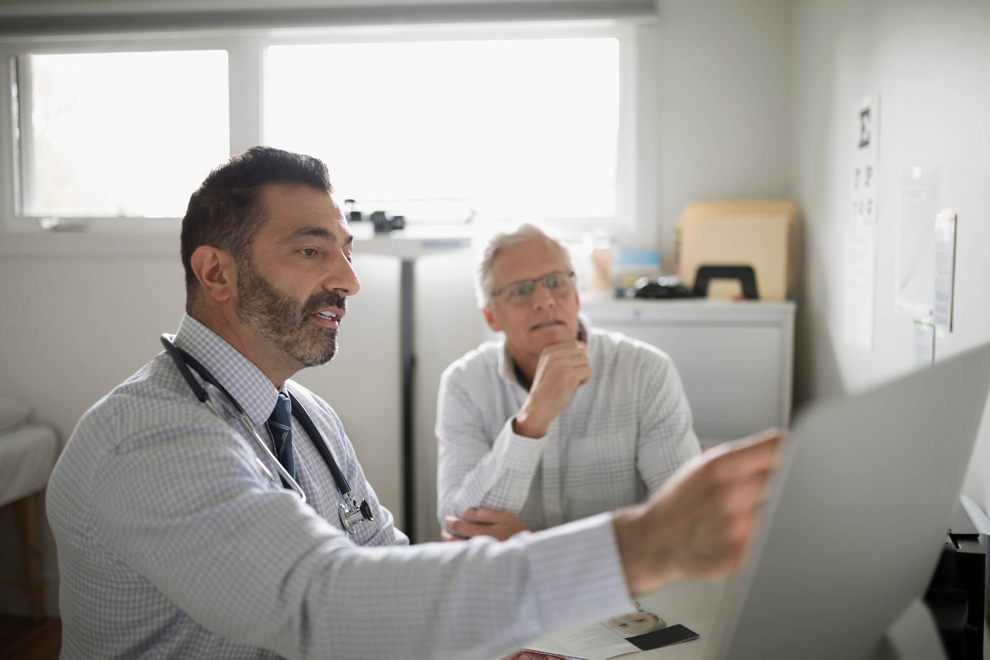 Physician discussing chart with patient