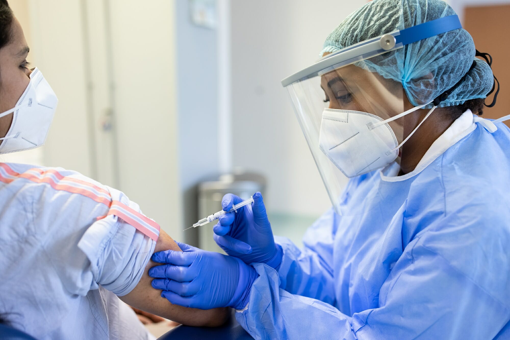 Provider vaccinating a patient