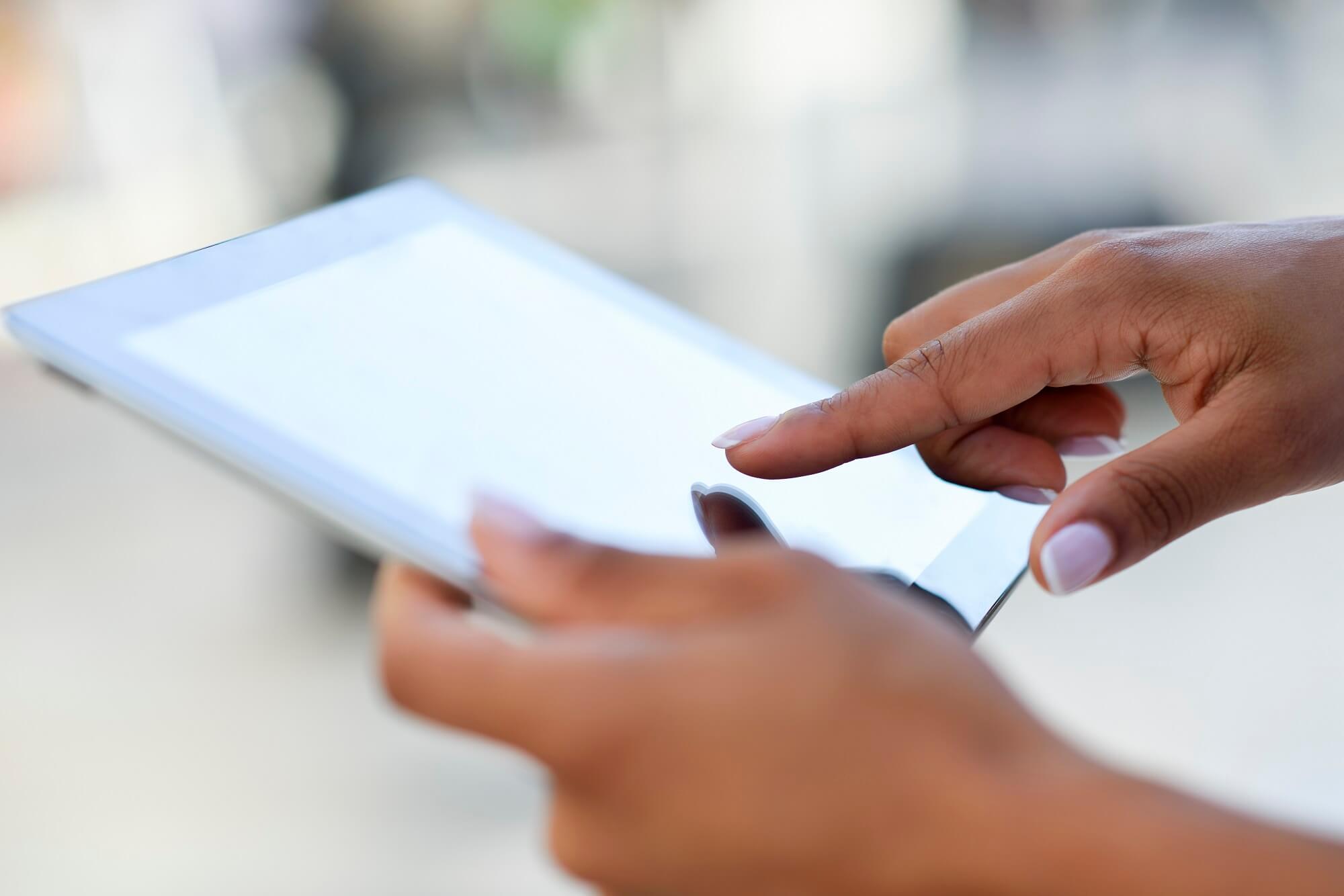 Closeup of a person using a digital tablet.