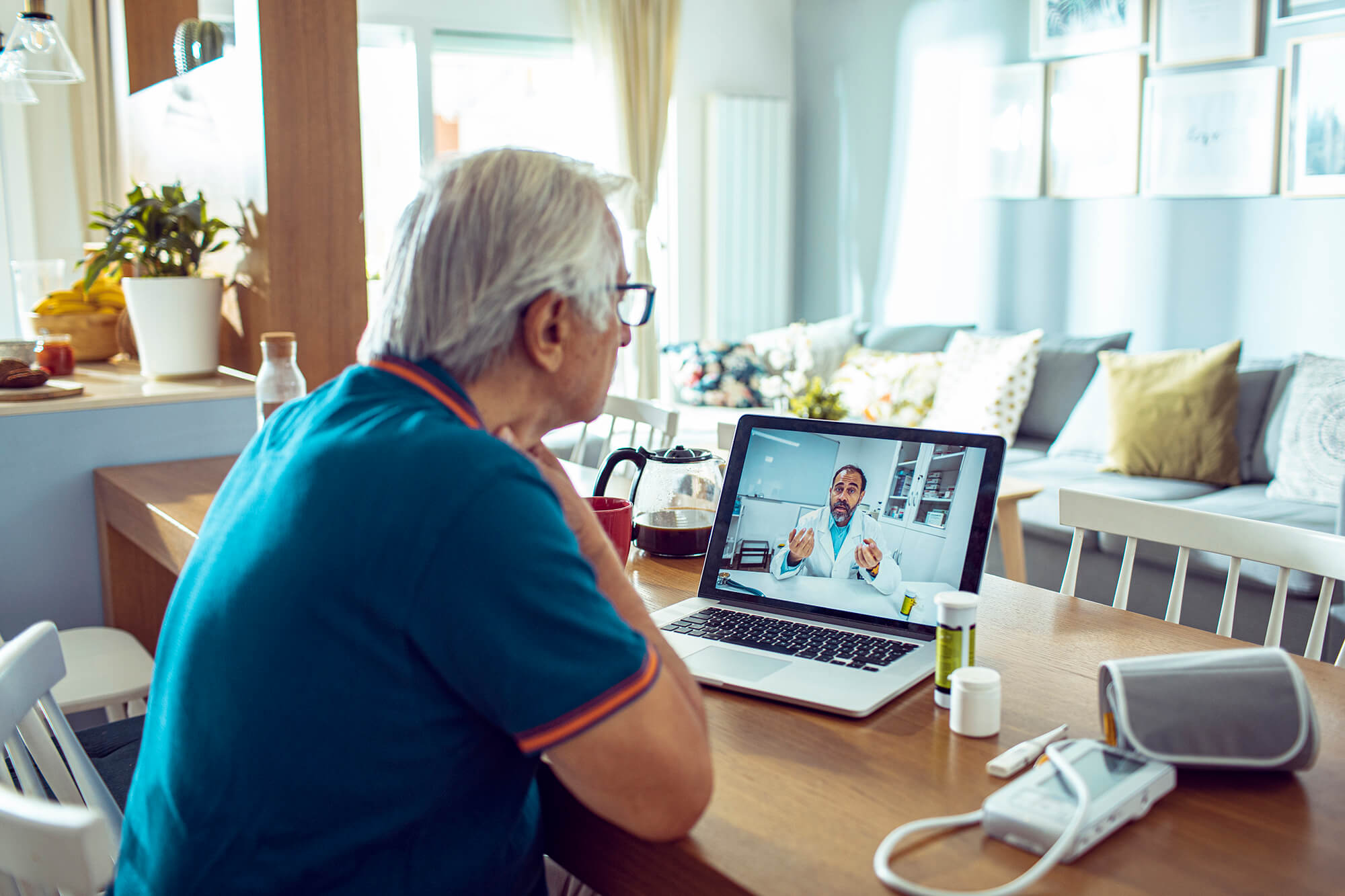 Senior man consulting with a doctor on his laptop.