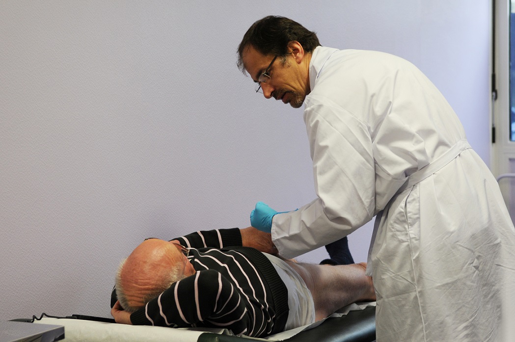 Urology consult: Senior man lying on exam table